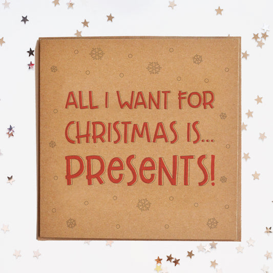 A funny Christmas card in festive colours and the message "All I Want For Christmas Is Presents".