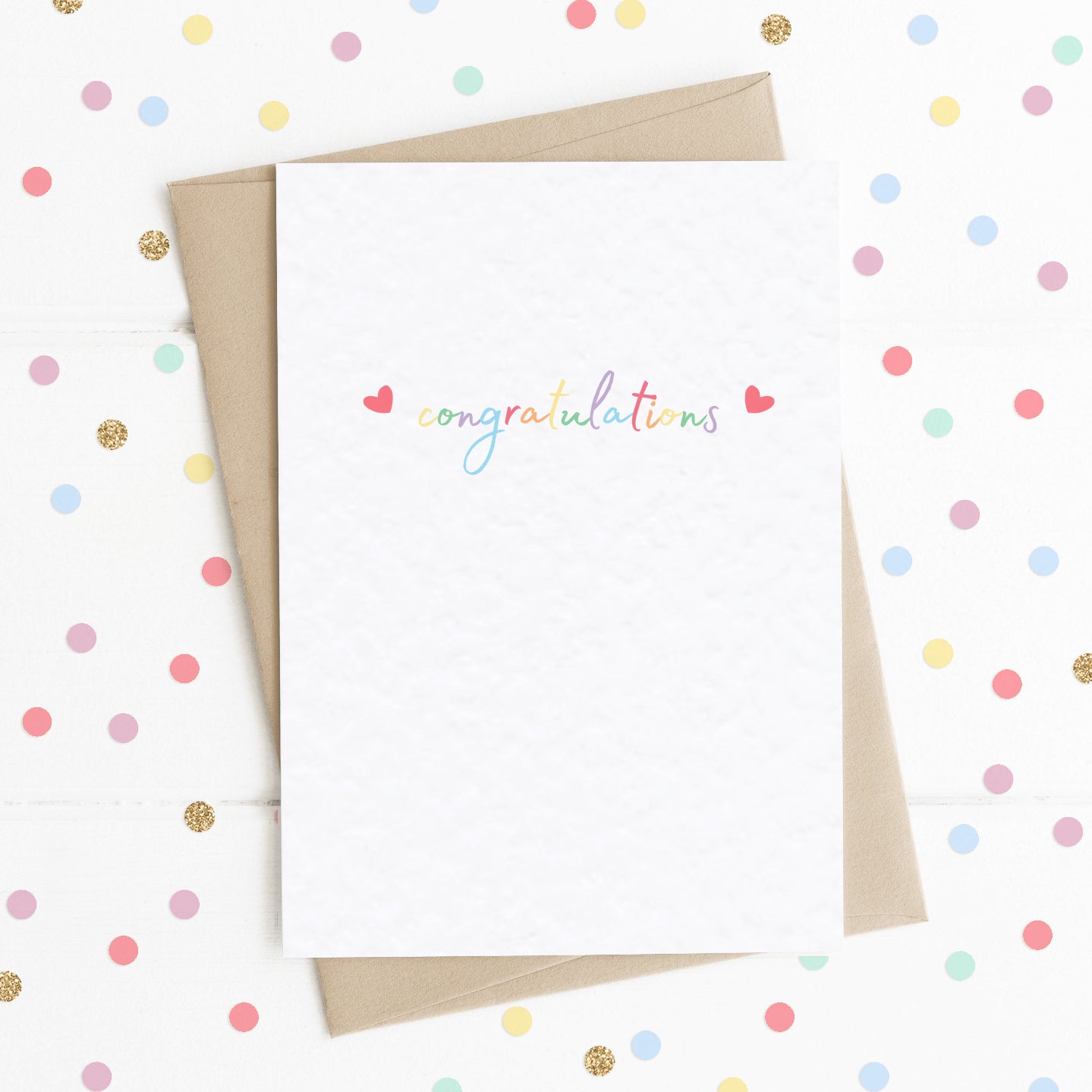 A cute A6 celebration card with the message "Congratulations" in colourful rainbow type, with two reds hearts either side.
