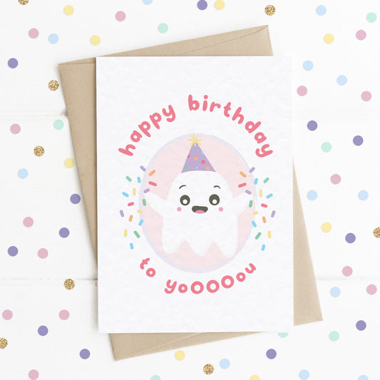 A cute seasonal birthday card with a smiling happy ghost on it, throwing colourful confetti, with the message "Happy Birthday To Yooooou".