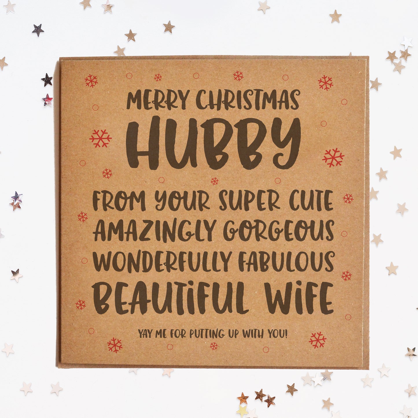 A funny Christmas card for the husband, in festive colours and a message saying "MERRY CHRISTMAS HUBBY! FROM YOUR SUPER CUTE, AMAZINGLY GORGEOUS, WONDERFULLY FABULOUS BEAUTIFUL WIFE! YAY ME FOR PUTTING UP WITH YOU!"