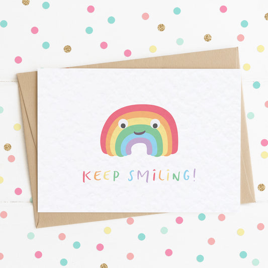 A cute positivity card with a smiling happy rainbow on it and the message "Keep Smiling".