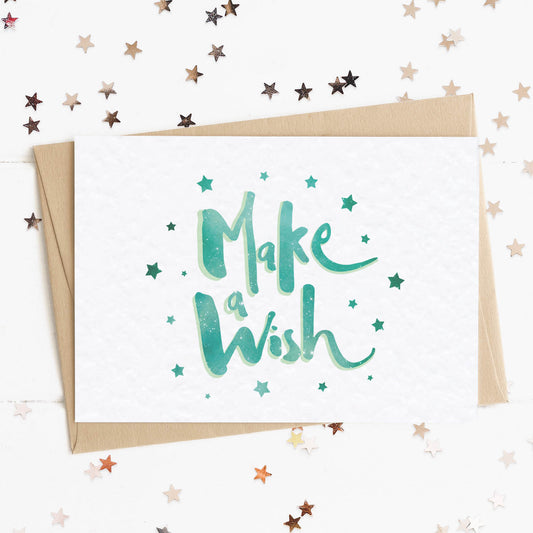 A cool birthday card with a stars and text in colours inspired by the northern lights/hygge and the message, "Make A Wish".