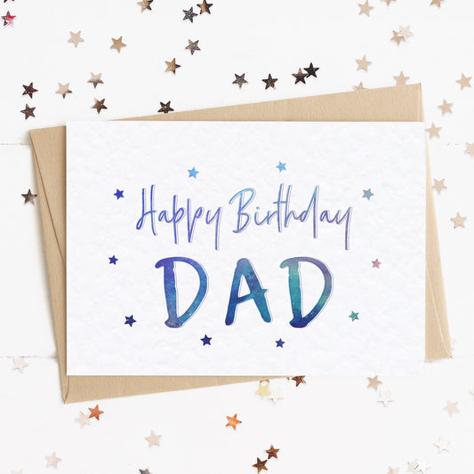 A dad birthday card with a stars and text in colours inspired by the northern lights/universe and the message, "Happy Birthday Dad".