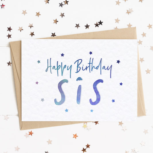 A sister birthday card with a stars and text in colours inspired by the northern lights/universe and the message, "Happy Birthday Sis".