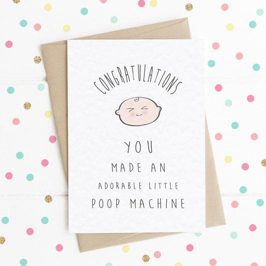 A funny new baby card for new parents, with a happy smiling baby illustration and the message saying "CONGRATULATIONS! YOU MADE AN ADORABLE LITTLE POOP MACHINE".