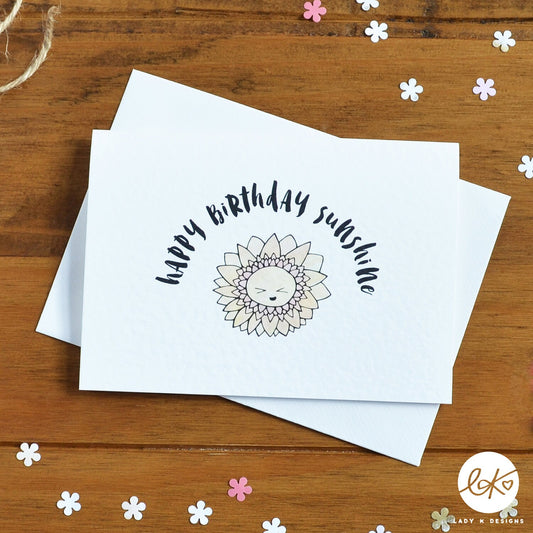 An A6 size card, with a cute smiling happy flower design, with the message "Happy Birthday Sunshine".