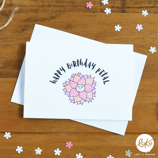 An A6 size card, with a cute smiling happy flower design, with the message "Happy Birthday Petal".