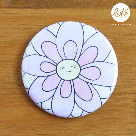 Cute 58mm Pocket Mirror with a smiling happy flower design. The characters name is Daisy Doo.