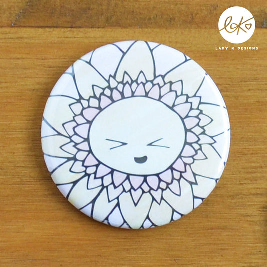 A cute 58mm Pocket Mirror with a smiling happy flower design. The characters name is Sunny.