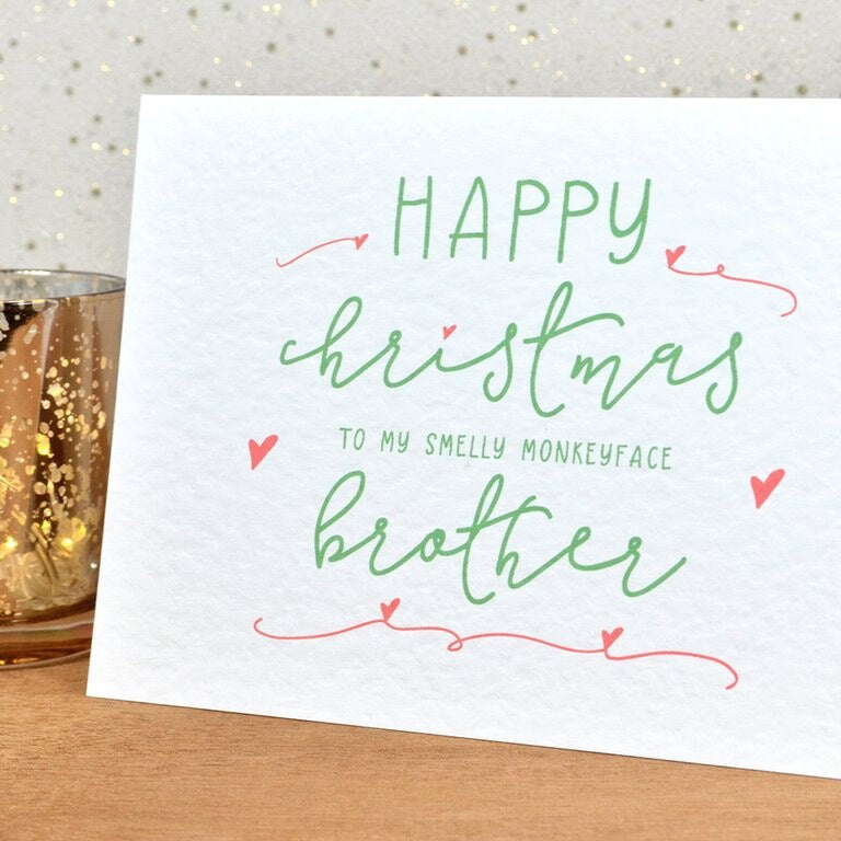 A funny Christmas card in festive colours and the message "Merry Christmas To My Smelly Monkeyface Brother".