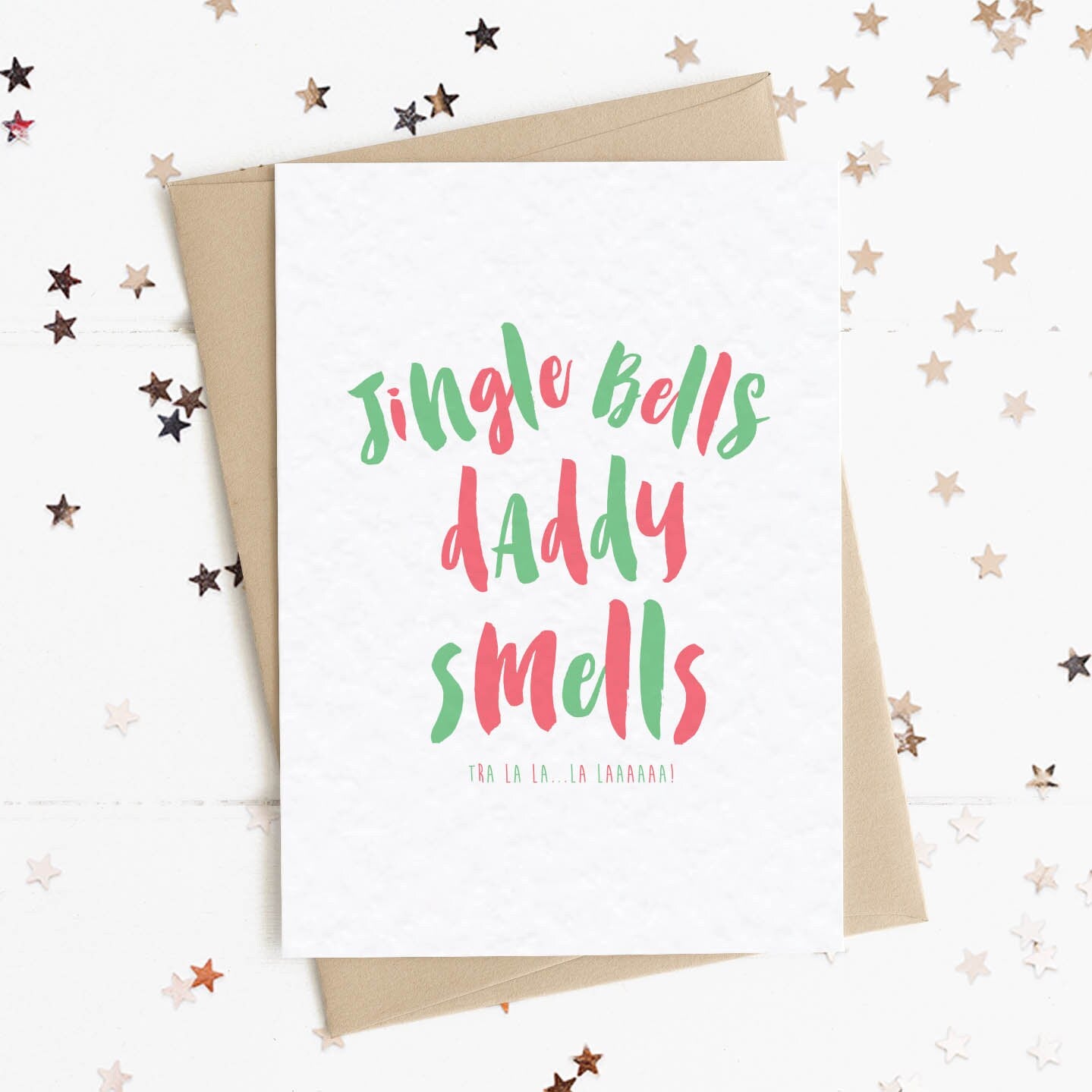 A funny Christmas card in festive colours and the message "Jingle Bells My Daddy Smells".