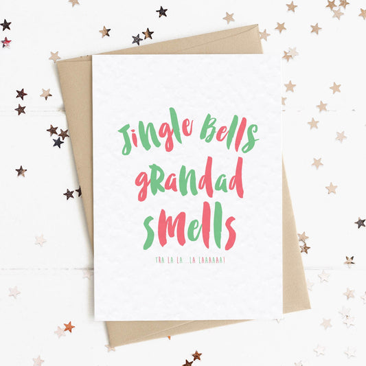 A funny Christmas card in festive colours and the message "Jingle Bells Grandad Smells".