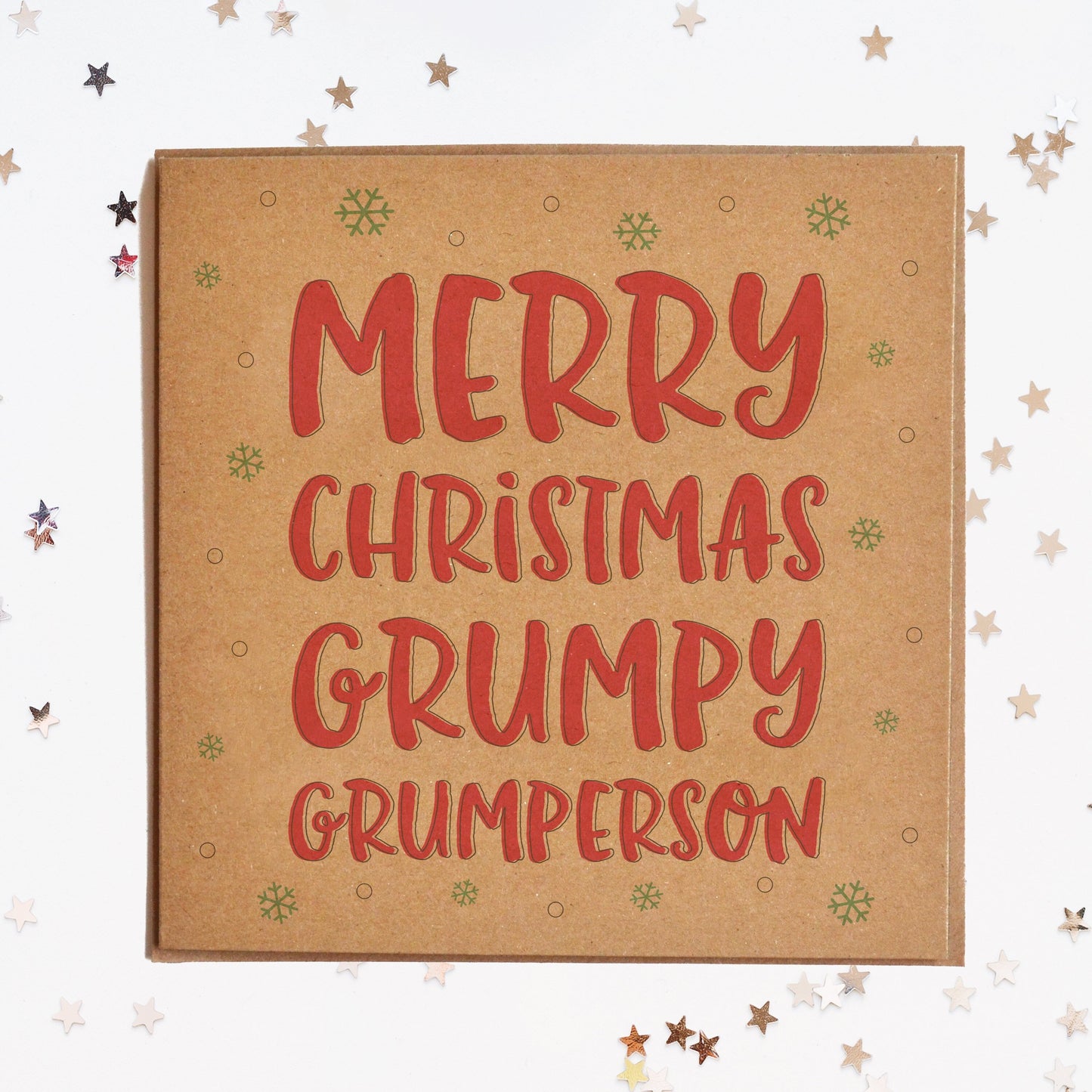 A funny Christmas card in festive colours and the message "Merry Christmas Grumpy Grumperson" surrounded by decorative snowflakes.