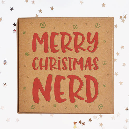 A funny Christmas card in festive colours and the message "Merry Christmas Nerd" surrounded by decorative snowflakes.