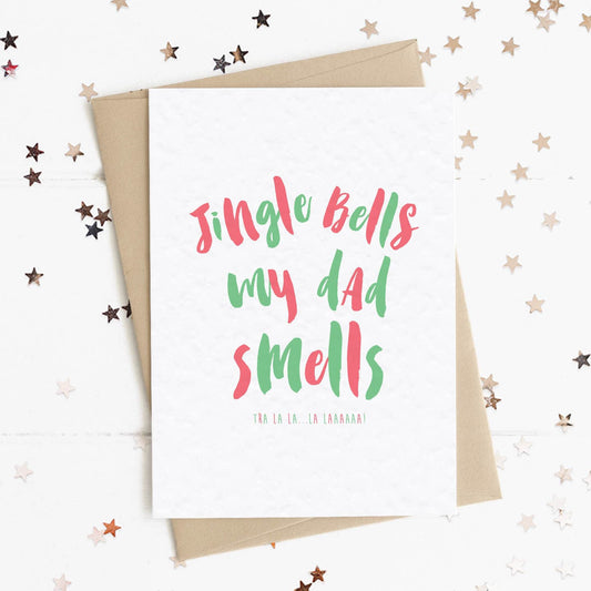 A funny Christmas card in festive colours and the message "Jingle Bells My Dad Smells".