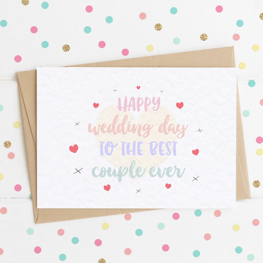 A cute wedding day card with a colourful pastel message saying "Happy Wedding Day To The Best Couple Ever" surrounded by complimenting hearts and x kisses.