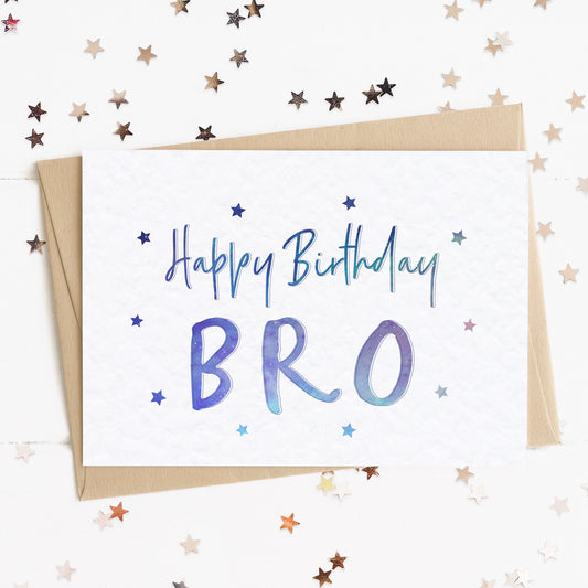 A brother birthday card with a stars and text in colours inspired by the northern lights/universe and the message, "Happy Birthday Bro"..