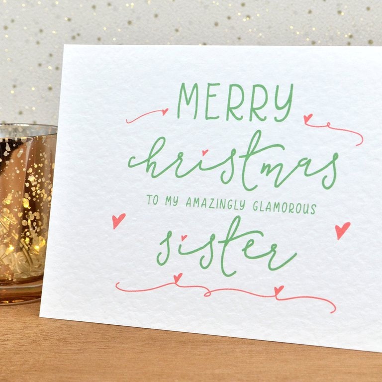 A fun and thoughtful Christmas card in festive colours and the message "Merry Christmas To My Amazingly Glamorous Sister".
