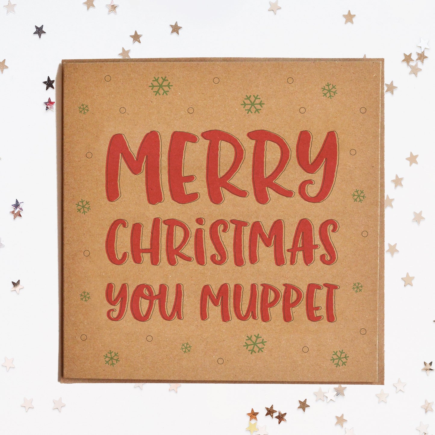A funny Christmas card in festive colours and the message "Merry Christmas You Muppet" surrounded by decorative snowflakes.